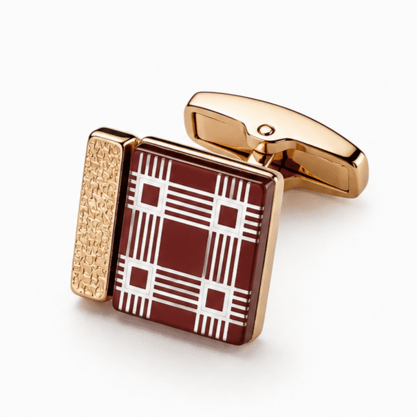 Close-up view of luxury burgundy and gold plaid square cufflinks for men.