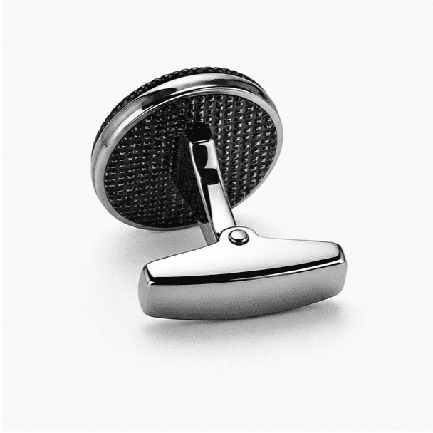 Side view of silver round cufflinks showing toggle bar clasp and textured black back plate