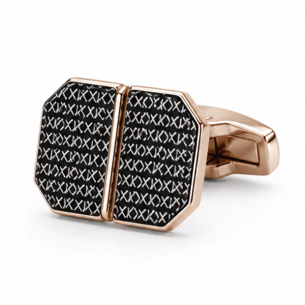 Close-up of rose gold octagonal cufflinks with black XO cross engraved pattern