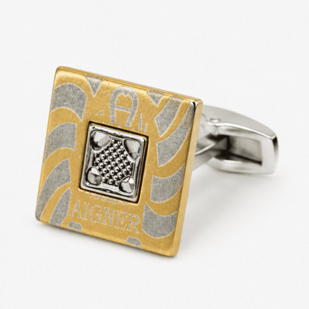 Close up view of square gold and silver designer cufflinks with detailed center design