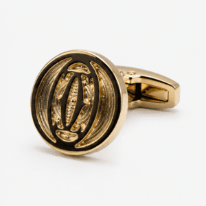 Close up view of two tone antique gold cufflinks with embossed design