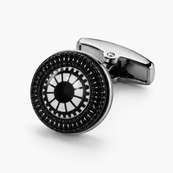 : Close-up of silver and black round cufflinks with gear wheel and sunburst engraved pattern