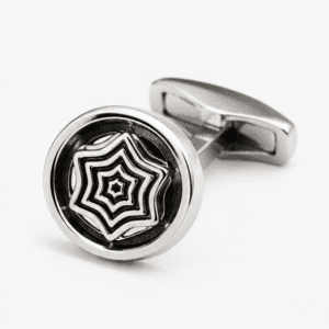Close up view of round silver cufflink with geometric pattern