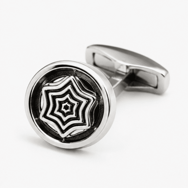 Close up view of round silver cufflink with geometric pattern