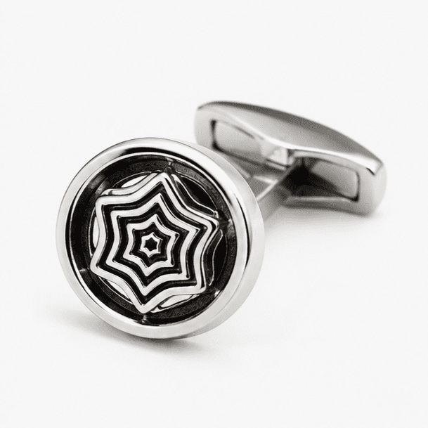 Close up view of round silver cufflink with geometric pattern